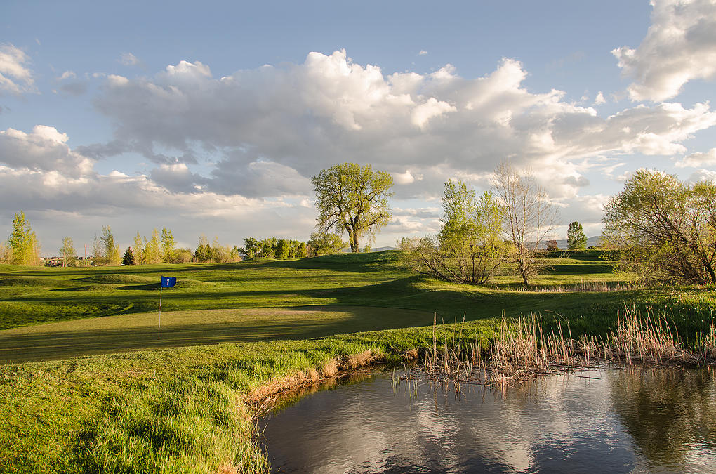 View of golf course with pond